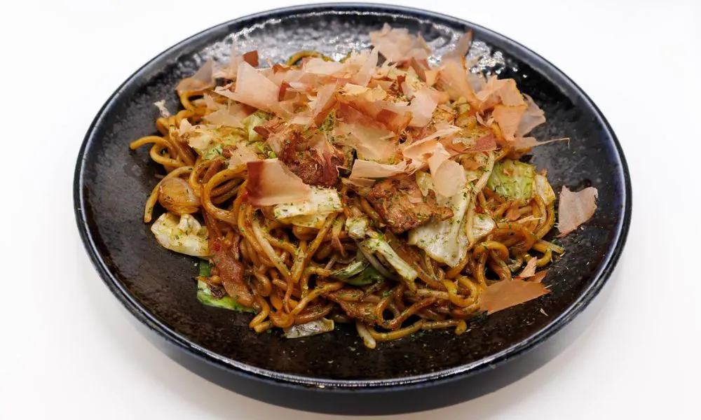 Savory Japanese fried udon topped with bonito flakes at Chibo, a Japanese Restaurant in Torrance